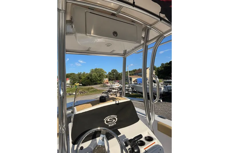 Slide: The Image of 2023 Sportsman Open 212 Center Console boat interior with steering wheel and console view. - 8