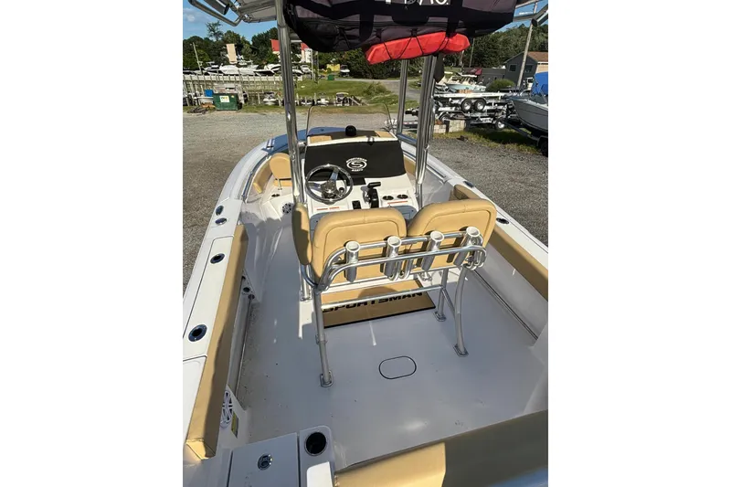 Slide: The Image of 2023 Sportsman Open 212 Center Console boat with tan seating and steering console. - 9