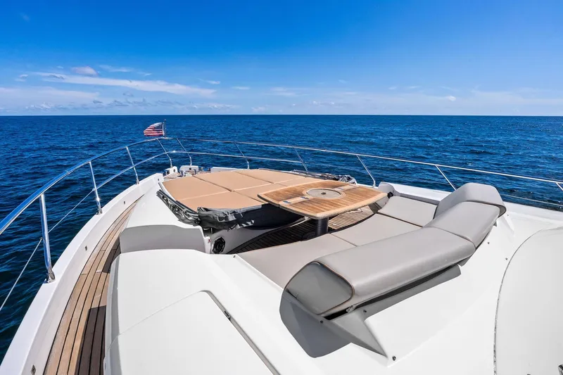 Slide: The Image of Luxurious 2013 Absolute 64 yacht deck with sunbeds, table, and ocean view. - 12
