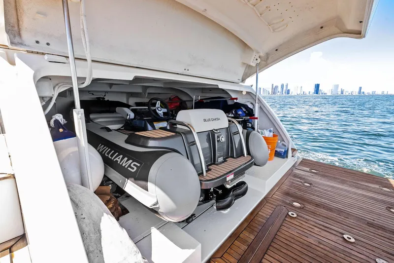 Slide: The Image of Luxury yacht Absolute 64 with Williams tender in storage, ocean view, city skyline in background. - 15