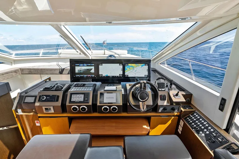 Slide: The Image of Cockpit of 2013 Absolute 64 yacht with navigation screens and steering wheel, overlooking the ocean. - 21
