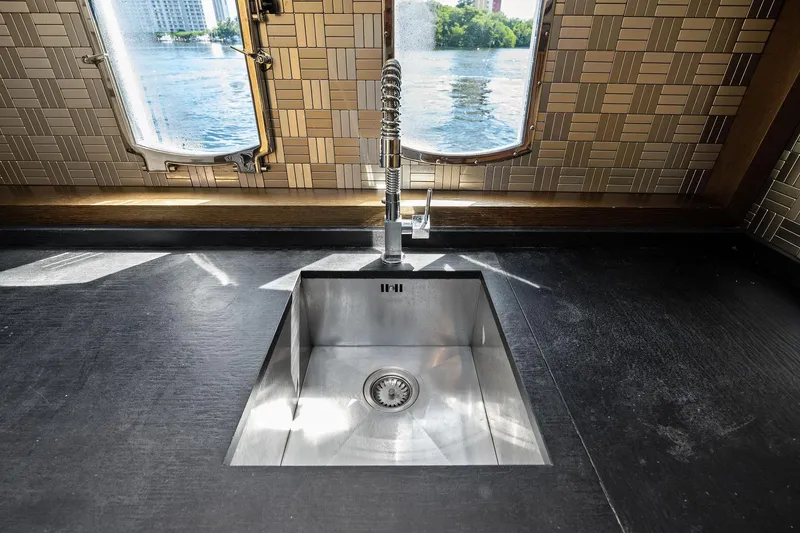 Slide: The Image of Modern kitchen sink on Absolute 64 yacht, 2013, with scenic water view through windows. - 42