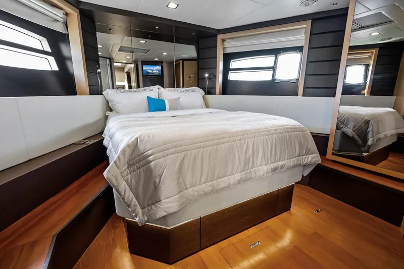 Slide: The Image of Luxurious bedroom interior on a 2013 Absolute 64 yacht, featuring elegant bedding and modern design. - 43