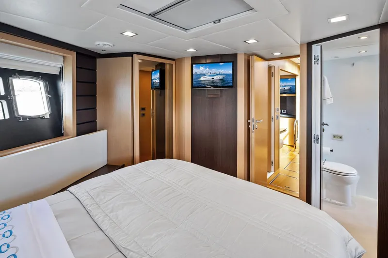 Slide: The Image of Luxurious bedroom interior on 2013 Absolute 64 yacht, featuring modern design and en-suite bathroom. - 49