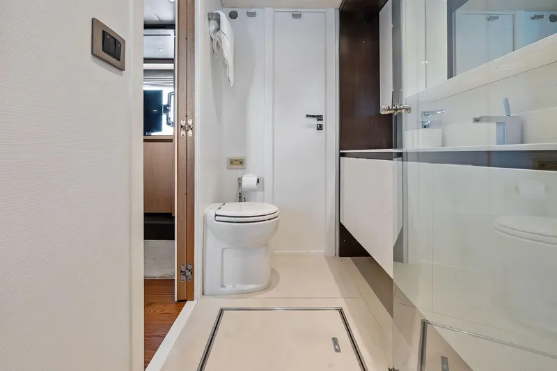 Slide: The Image of Luxurious bathroom on a 2013 Absolute 64 yacht, featuring modern fixtures and sleek design. - 55
