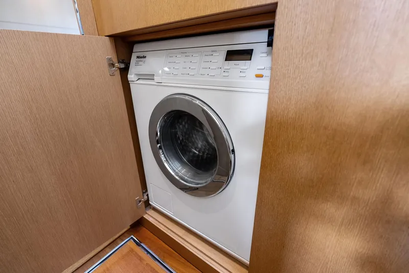 Slide: The Image of Built-in washing machine on Absolute 64 yacht, 2013 model, behind wooden cabinet door. - 57