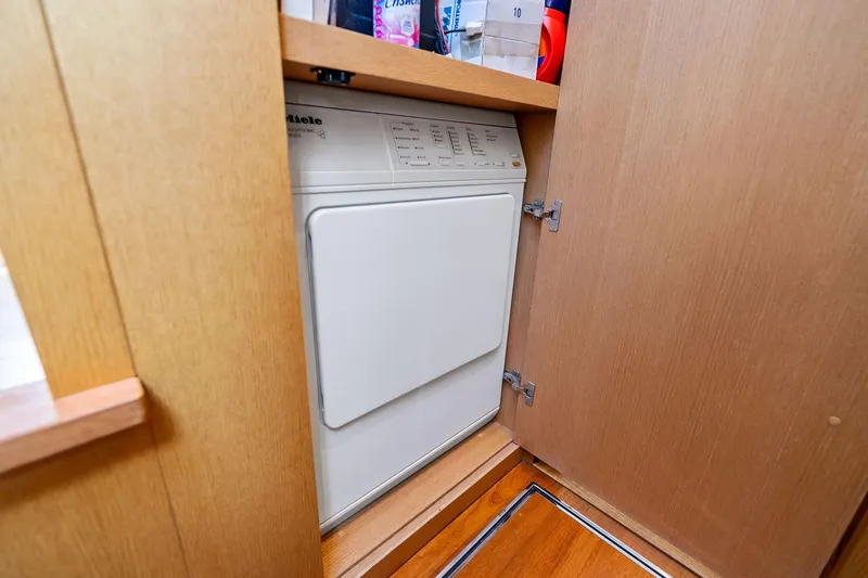 Slide: The Image of Laundry area with a Miele appliance in a 2013 Absolute 64 yacht. - 58