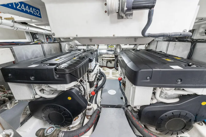 Slide: The Image of Engine room of a 2013 Absolute 64 yacht, featuring dual engines and mechanical components. - 70