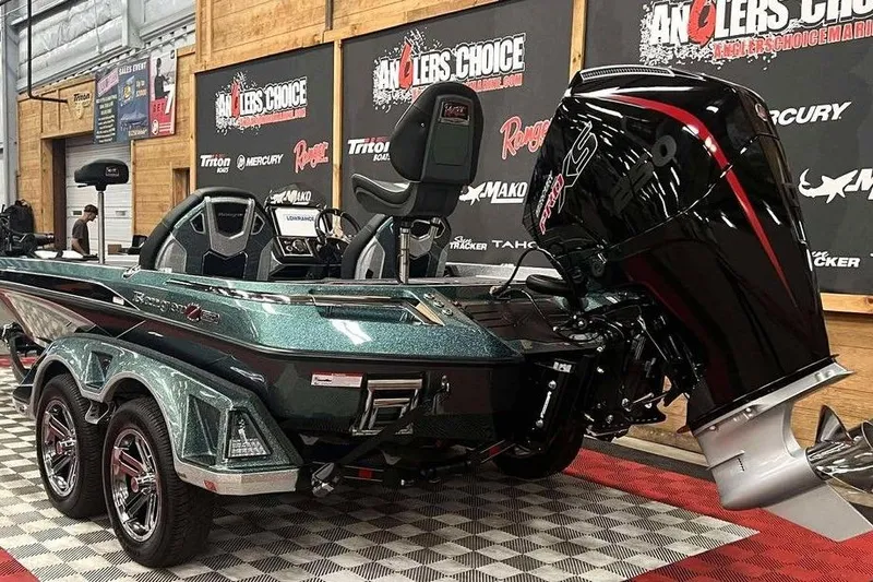 Slide: The Image of 2026 Ranger Z520R Cup-Equipped boat displayed indoors with powerful outboard motor. - 2