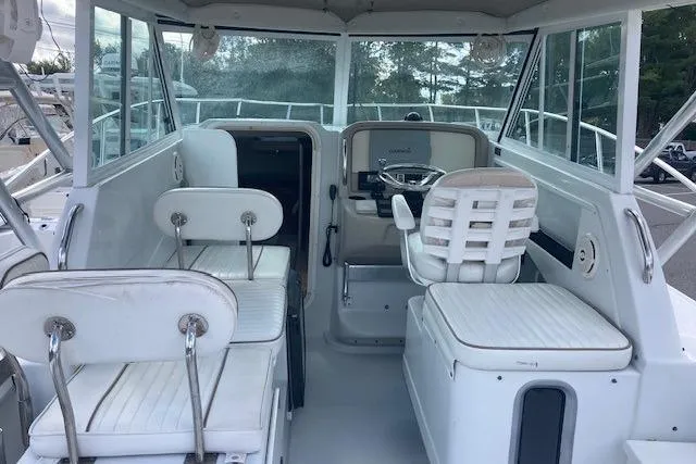 Slide: The Image of 2008 Glacier Bay 2685 Coastal Runner boat interior with white seating and steering area. - 10