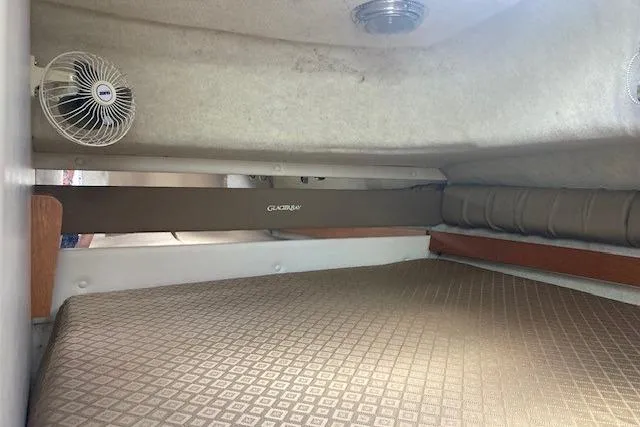 Slide: The Image of Interior cabin of 2008 Glacier Bay 2685 Coastal Runner with fan and cushioned bed. - 14