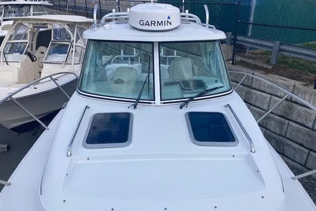 Slide: The Image of 2008 Glacier Bay 2685 Coastal Runner boat with Garmin radar, docked near other vessels. - 3