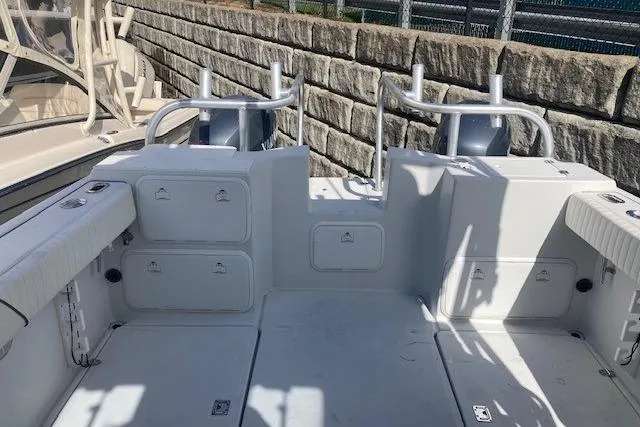 Slide: The Image of 2008 Glacier Bay 2685 Coastal Runner boat interior with storage compartments and rod holders. - 6