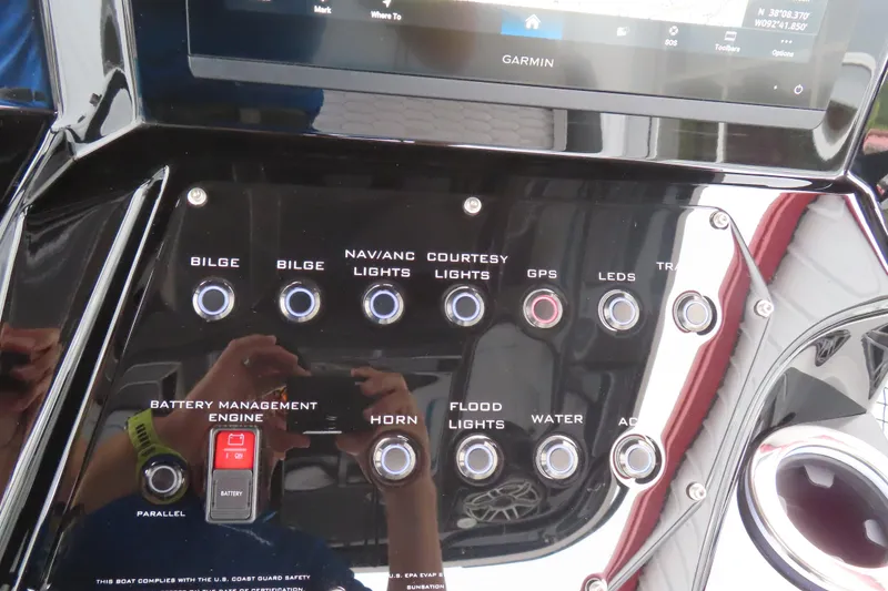 Slide: The Image of Control panel of 2026 Sunsation 32CCX boat with various switches and Garmin display. - 7