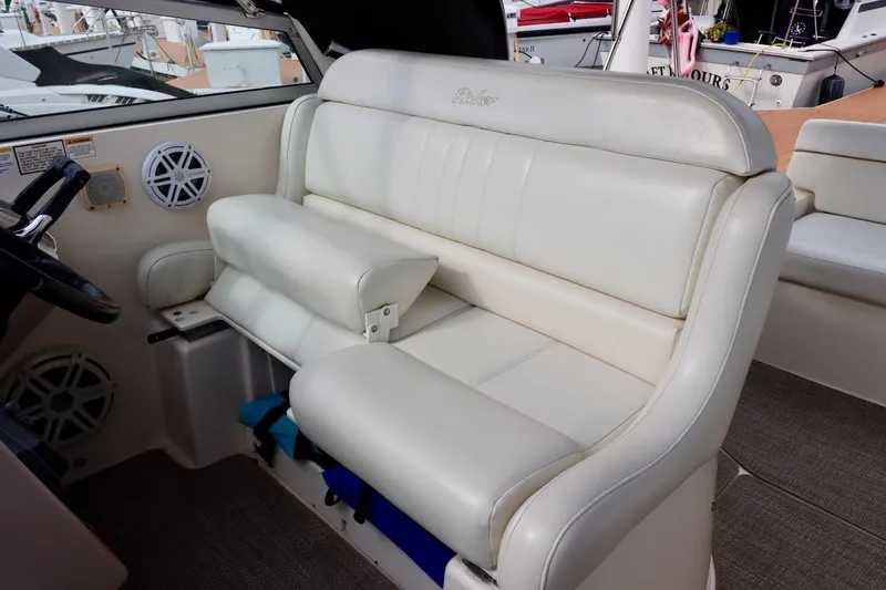 Slide: The Image of 2006 Rinker 360 Express Cruiser interior with white leather seating and steering wheel. - 11