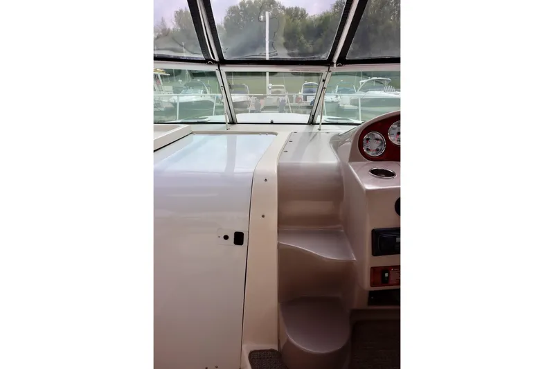 Slide: The Image of 2006 Rinker 360 Express Cruiser helm with gauges and windshield view. - 13