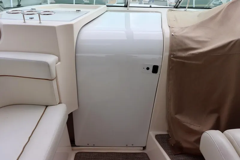 Slide: The Image of 2006 Rinker 360 Express Cruiser interior with white seating and covered console. - 15