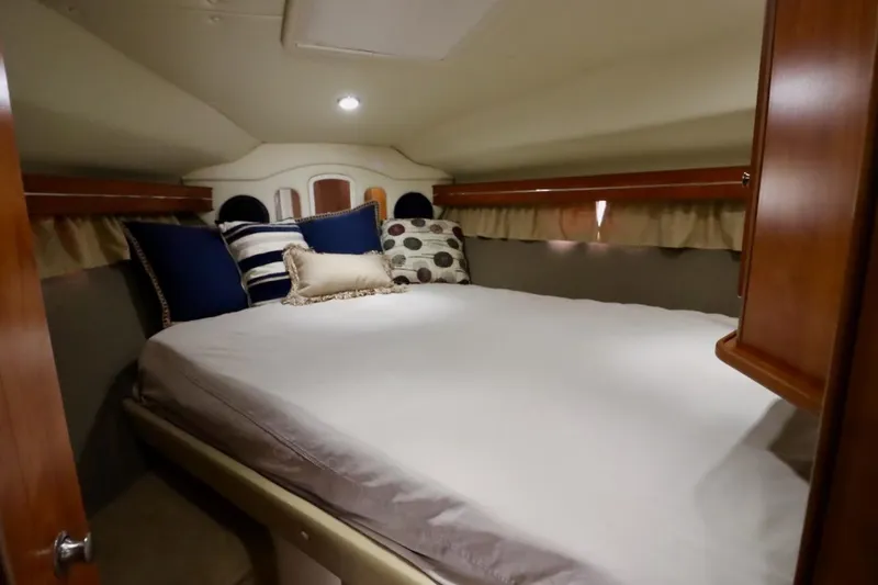 Slide: The Image of Cozy cabin interior of 2006 Rinker 360 Express Cruiser with plush bedding and pillows. - 21