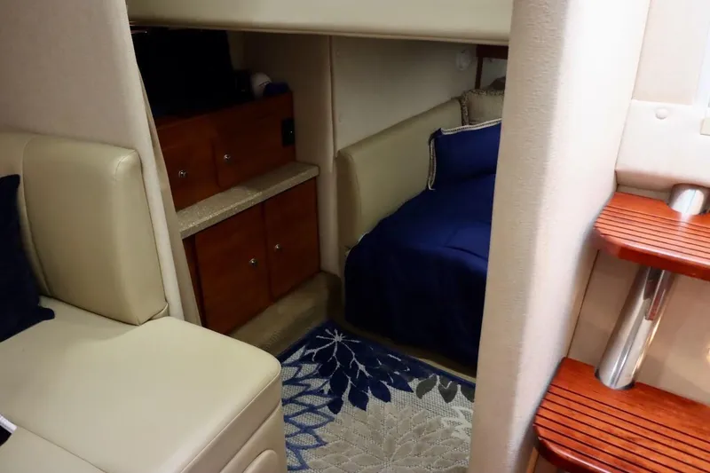 Slide: The Image of Interior of 2006 Rinker 360 Express Cruiser with cozy seating and wooden cabinetry. - 23