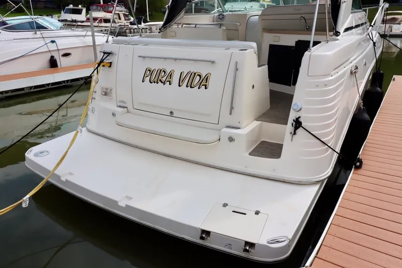 Slide: The Image of 2006 Rinker 360 Express Cruiser docked, featuring "Pura Vida" on the stern. - 3