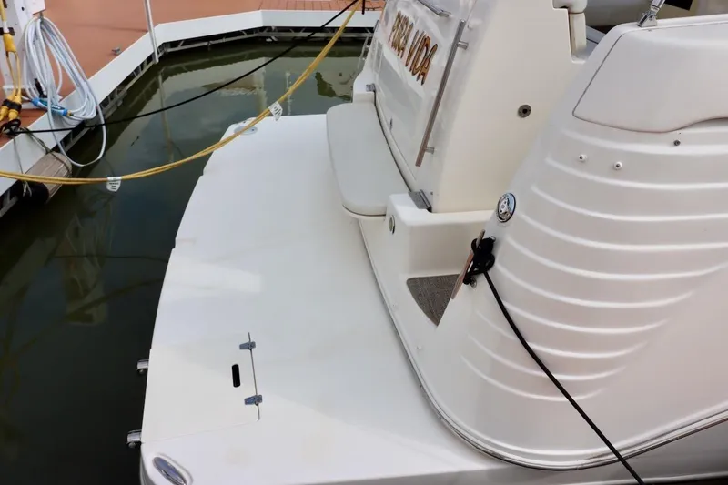 Slide: The Image of 2006 Rinker 360 Express Cruiser docked, showing rear deck and mooring lines. - 5