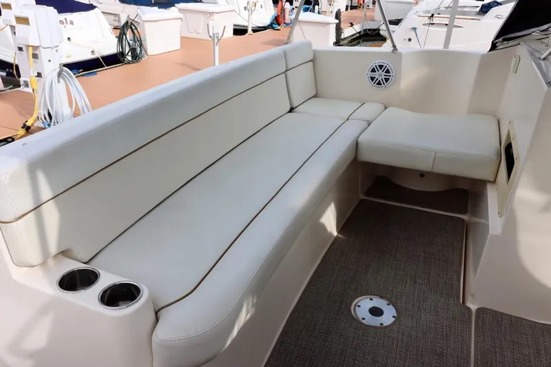 Slide: The Image of 2006 Rinker 360 Express Cruiser interior with white seating and cup holders. - 6