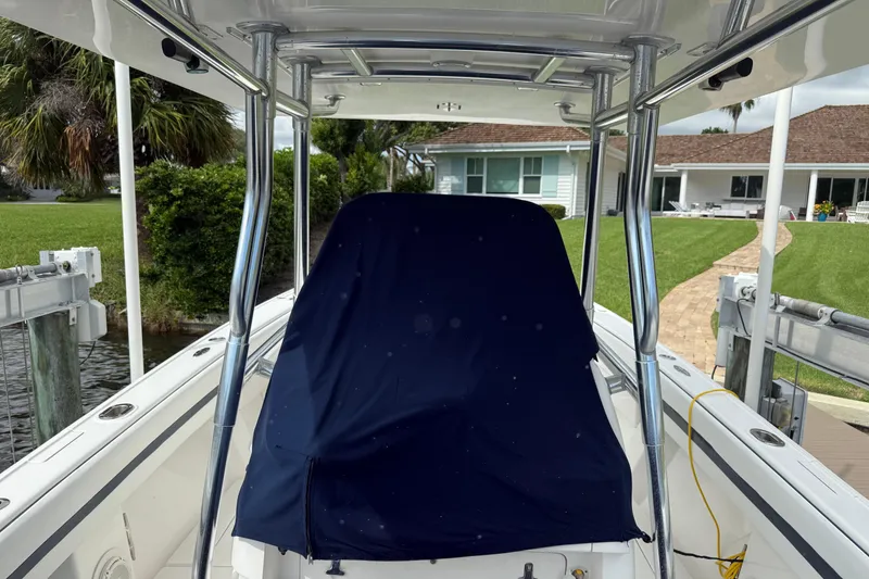 Slide: The Image of 2009 Intrepid 323 boat with covered console, docked near waterfront homes. - 15