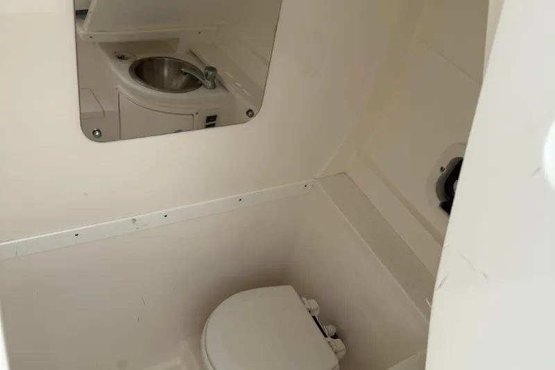 Slide: The Image of Compact bathroom in 2009 Intrepid 323 boat with sink and toilet. - 7