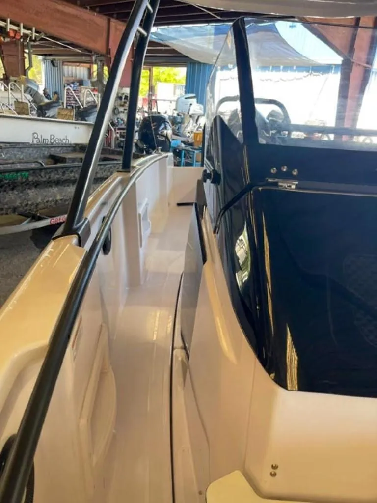 Slide: The Image of 2023 Axopar 22 T-Top boat interior view in a marina. - 12