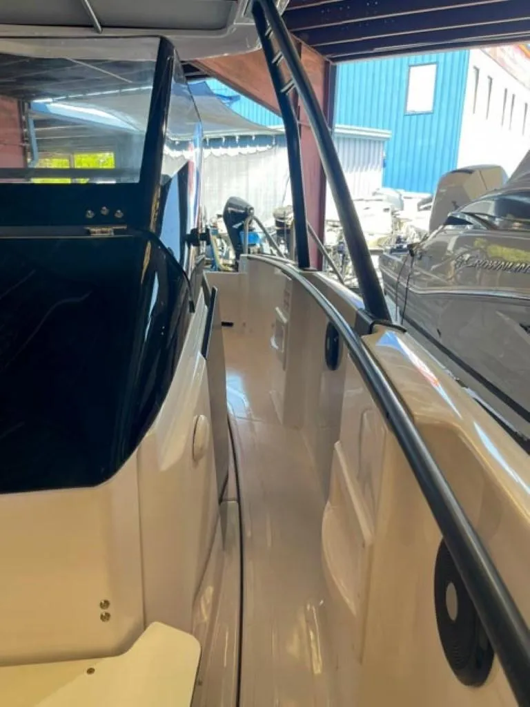 Slide: The Image of 2023 Axopar 22 T-Top boat interior view in a marina. - 13