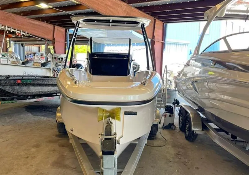 Slide: The Image of 2023 Axopar 22 T-Top boat in storage, front view. - 2