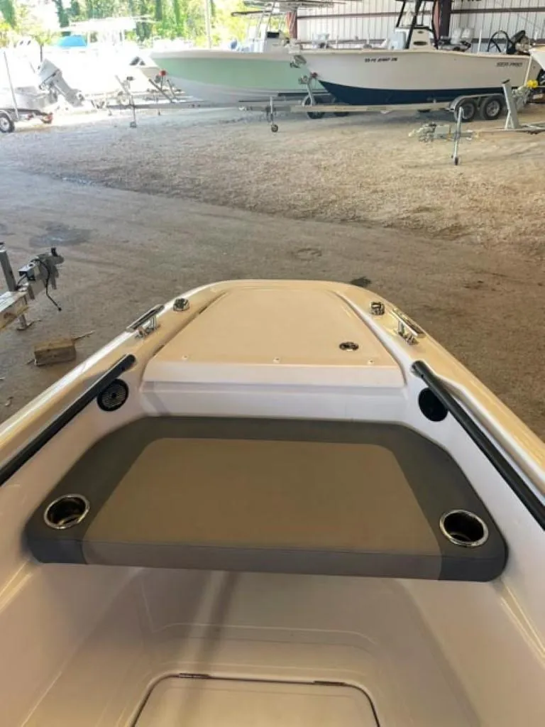 Slide: The Image of 2023 Axopar 22 T-Top boat interior with seating and cup holders. - 4