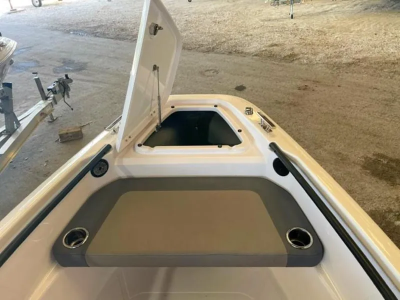 Slide: The Image of 2023 Axopar 22 T-Top boat with open storage compartment and seating area. - 5