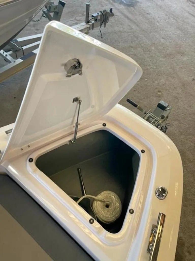 Slide: The Image of Open storage compartment on a 2023 Axopar 22 T-Top boat. - 6