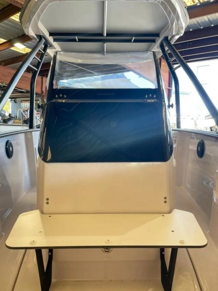 Slide: The Image of 2023 Axopar 22 T-Top boat interior with seating and windshield. - 7