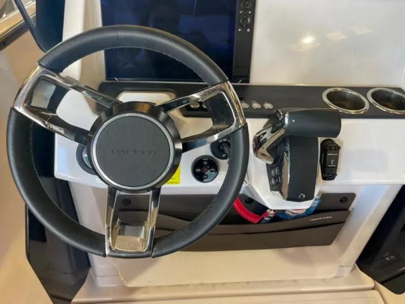 Slide: The Image of 2023 Axopar 22 T-Top steering wheel and control panel. - 8