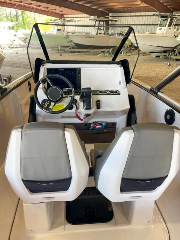 Slide: The Image of 2023 Axopar 22 T-Top boat interior with dual seats and control console. - 9