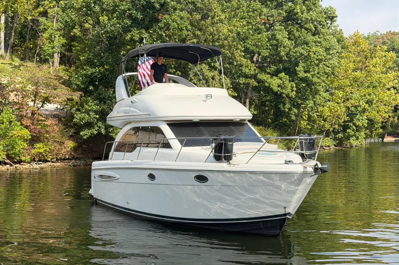 Slide: The Image of 2004 Meridian 341 Sedan cruising on a serene lake with lush green trees. - 10