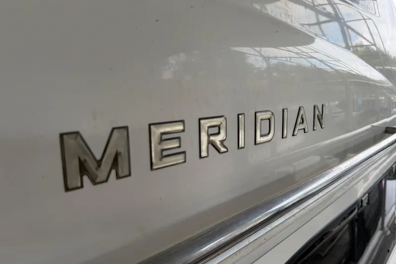 Slide: The Image of Close-up of 2004 Meridian 341 Sedan boat nameplate on white hull. - 14