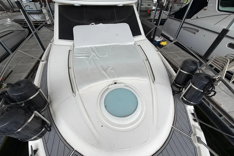 Slide: The Image of 2004 Meridian 341 Sedan yacht docked, featuring a sleek deck and protective fenders. - 15