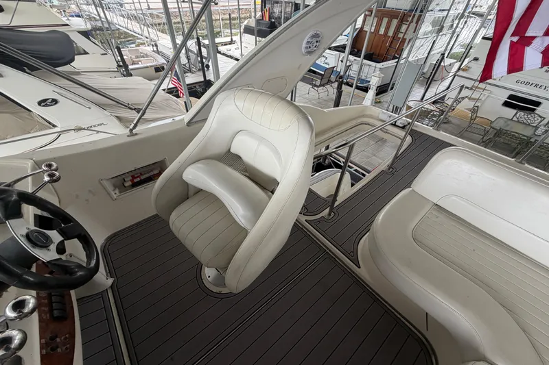 Slide: The Image of 2004 Meridian 341 Sedan boat interior with captain's chair and steering wheel. - 21