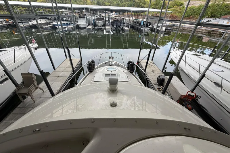 Slide: The Image of 2004 Meridian 341 Sedan docked in a marina with surrounding boats. - 23
