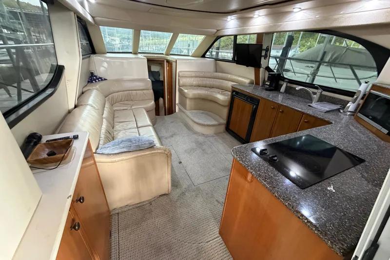 Slide: The Image of Luxurious interior of a 2004 Meridian 341 Sedan yacht with leather seating and modern kitchen amenities. - 25
