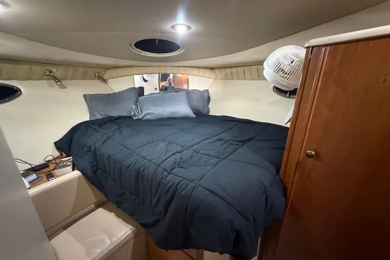 Slide: The Image of Cozy cabin interior of 2004 Meridian 341 Sedan with bed and wooden cabinetry. - 31