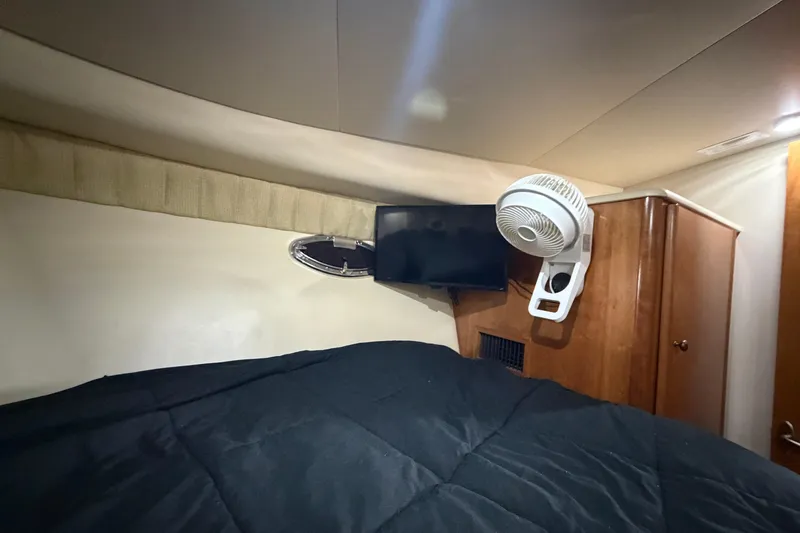 Slide: The Image of 2004 Meridian 341 Sedan interior with bed, TV, and fan. - 32