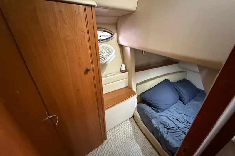 Slide: The Image of 2004 Meridian 341 Sedan cabin interior with cozy bed and wooden cabinetry. - 33