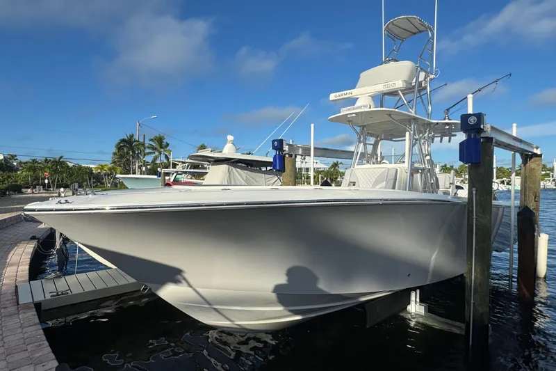 Slide: The Image of 2022 SeaVee 322 Z boat docked at marina under clear blue sky. - 12