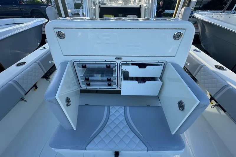 Slide: The Image of 2022 SeaVee 322 Z boat with open storage compartments and cushioned seating. - 14