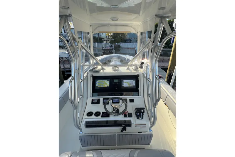 Slide: The Image of 2022 SeaVee 322 Z boat console with navigation screens and steering wheel. - 15