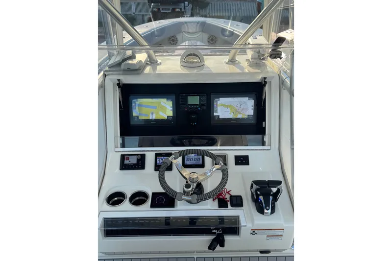 Slide: The Image of 2022 SeaVee 322 Z boat dashboard with dual navigation screens and steering wheel. - 16